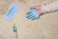 Syringe surgical mask and hand with torn gloves