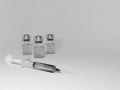 Syringe and three vials with transparent liquid inside