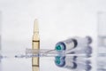 Syringe with transparent liquid and ampule Royalty Free Stock Photo