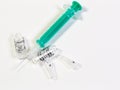 A syringe and two broken ampules on white background Royalty Free Stock Photo