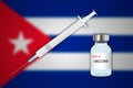 Syringe and vaccine vial on blur background with Cuba flag