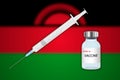 Syringe and vaccine vial on blur background with Malawi flag