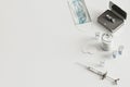 Syringe, vials, face mask on white background from above, coronavirus vaccination concept, medical supplies equipment on table,