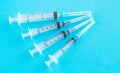 Syringes on a blue background. Syringes of different volumes. Concept - vaccination. Production of medical devices Royalty Free Stock Photo