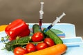 Syringes with chemicals on vegetables,