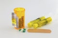 Prescription bottle with warning labels, pills, syringe, supplies Royalty Free Stock Photo