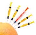 Syringes and orange. Royalty Free Stock Photo
