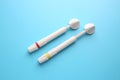 Syringes of resin luting cement on color background