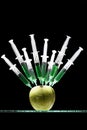 Syringes stuck in an apple Royalty Free Stock Photo