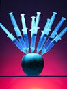 Syringes stuck in an apple Royalty Free Stock Photo