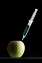 Syringes stuck in an apple Royalty Free Stock Photo