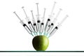 Syringes stuck in an apple Royalty Free Stock Photo