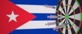 Syringes with a vaccine hit target near the Cuban flag. Successful medical research and vaccination in Cuba. Conceptual