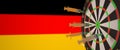 Syringes with a vaccine hit target near the German flag. Successful research and vaccination in Germany. Conceptual 3D