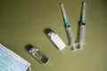 syringes, vials and medical masks on the table