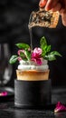 Syrup being poured on a dessert with whipped cream and flowers on a dark background setting elegantly Royalty Free Stock Photo