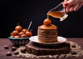 Syrup from Chinese apples jam pouring on stack of chestnut pancakes