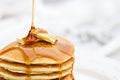 Syrup Pouring onto a Stack of Pancakes