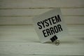 System Error text message write on sticky note on wooden background