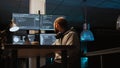 System programmer typing source code on laptop and multiple monitors Royalty Free Stock Photo