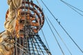 Ship`s mast with sail and ropes, close up, against clear blue sky background Royalty Free Stock Photo