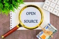 System and website builder concept. OPEN SOURCE through a magnifying glass on a white sheet of notepad Royalty Free Stock Photo