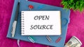 System and website builder concept. OPEN SOURCE in a mini notebook on a business book, top view. Copy space Royalty Free Stock Photo