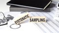 Systematic Sampling - text on a wooden block with chart and notebook
