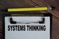 Systems Thinking write on a paperwork isolated on Wooden Table Royalty Free Stock Photo