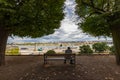 Szczecin, Zachodniopomorskie / Poland - August, 27, 2020: Older man sitting on a bench at the Port. View of the port and shipyards