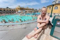 Szechenyi Baths in Budapest, Hungary. Young woman sits on a thermal bathing background