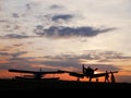 View on the airplanes on the Szeged Airport with the sunset in the background Royalty Free Stock Photo