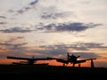 View on the airplanes on the Szeged Airport with the sunset in the background Royalty Free Stock Photo