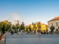 View on the ferris wheel in Zichy park and the people walking on the streets of Szekesfehervar Royalty Free Stock Photo