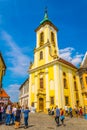 SZENTENDRE, HUNGARY MAY 22, 2016: People are walking in front of the blagovestenska Serbian orthodox church in Royalty Free Stock Photo
