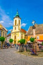 SZENTENDRE, HUNGARY MAY 22, 2016: People are walking in front of the blagovestenska Serbian orthodox church in Royalty Free Stock Photo