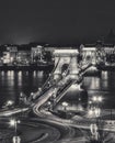 SzÃÂ©chenyi Chain Bridge illuminated at night in Budapest, Hungary black and white shot Royalty Free Stock Photo