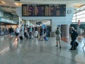 SÃ¡ Carneiro airport interior view, departures and arrivals information board, people walking with suitcases and bags and staying Royalty Free Stock Photo