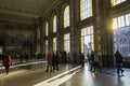 SÃÂ£o bento railway station illuminated by the warm light passing through the tall windows. People walking. Porto