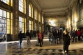 SÃÂ£o bento railway station illuminated by the warm light passing through the tall windows. People walking. Porto