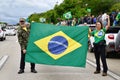 Couple hold the flag of Brazil on the edge of the dutra against the results of the polls