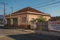 Outworn old house and wall with painted placard in empty street on the sunset at SÃÂ£o Manuel. Royalty Free Stock Photo