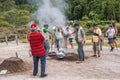 SÃÂ£o Miguel - Azores PORTUGAL - 9 August 2020 - Man photographing group of fumarole workers removing pan with boiler food cooked