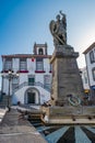 SÃÂ£o Miguel, Azores PORTUGAL - August 11, 2020 - Perspective of statue of Archangel SÃÂ£o Miguel in fountain with pigeons and Ponta