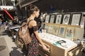 SÃÂ£o Paulo / SÃÂ£o Paulo / Brazil - 08 19 2018: Pretty young lovely model woman choosing a drawing or a painting to buy at market