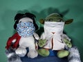 Snoopy and baby yoda stuffed animals wearing facial masks during the pandemic of covid-19