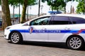 Ford car with sign and symbol of French national police parked in city street