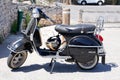 Vespa px 125 scooter with vintage look in city street parked with elmet Royalty Free Stock Photo