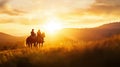 A pair of riders on horseback are silhouetted against a glowing sunset on a grassy landscape. Royalty Free Stock Photo