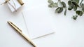A minimalistic composition on a white surface features a blank white card Royalty Free Stock Photo